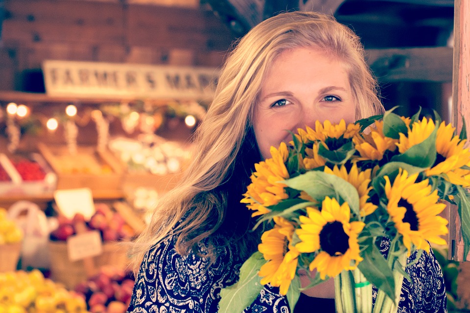 woman with a bouquet of supermarket sunflowers